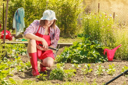 Staff using PPE while operating garden machinery