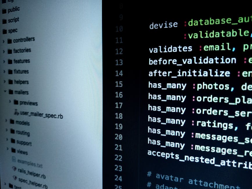A close-up photograph of a computer screen displaying lines of code with syntax highlighting in various colours such as green, blue, purple, and white on a dark background. To the left, a directory st